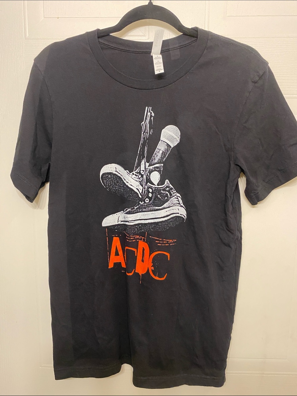 AC/DC Black Graphic Tee with White Illustration and Orange Logo